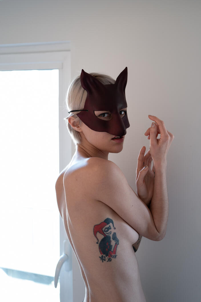 photograph, female figure, mask, interior, natural light